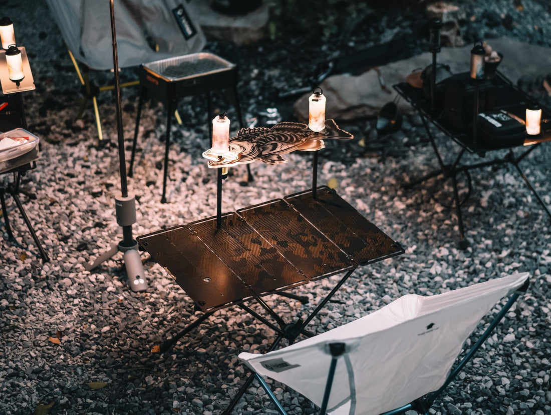ODAM MFT folding carbon tabletop with shelf and camping lights at an outdoor campsite