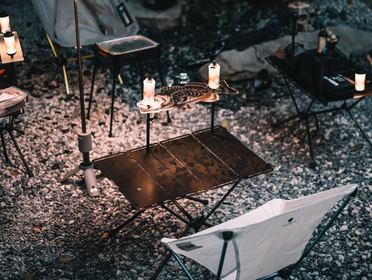 ODAM MFT folding carbon tabletop with shelf and camping lights at an outdoor campsite